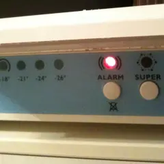 Panel kontrolny zamrażarki Whirlpool z migającą czerwoną diodą ALARM i przyciskami SUPER i ON.